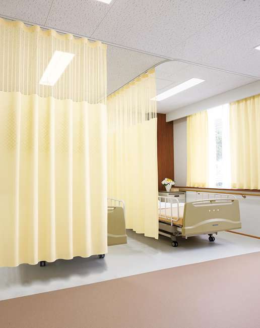 yellow hospital curtain dividing two patient beds in Dubai clinic